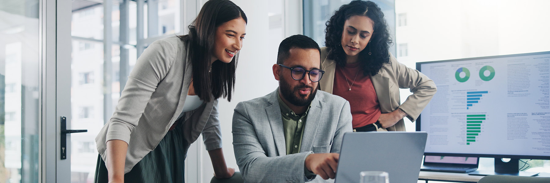 three people brainstorming on project while looking at laptop