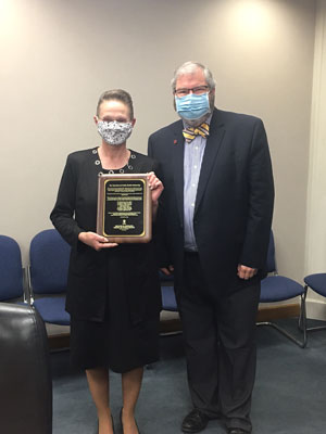 Tami Barrett poses with award alongside Paul Halverson