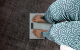 feet and legs of person standing on a scale